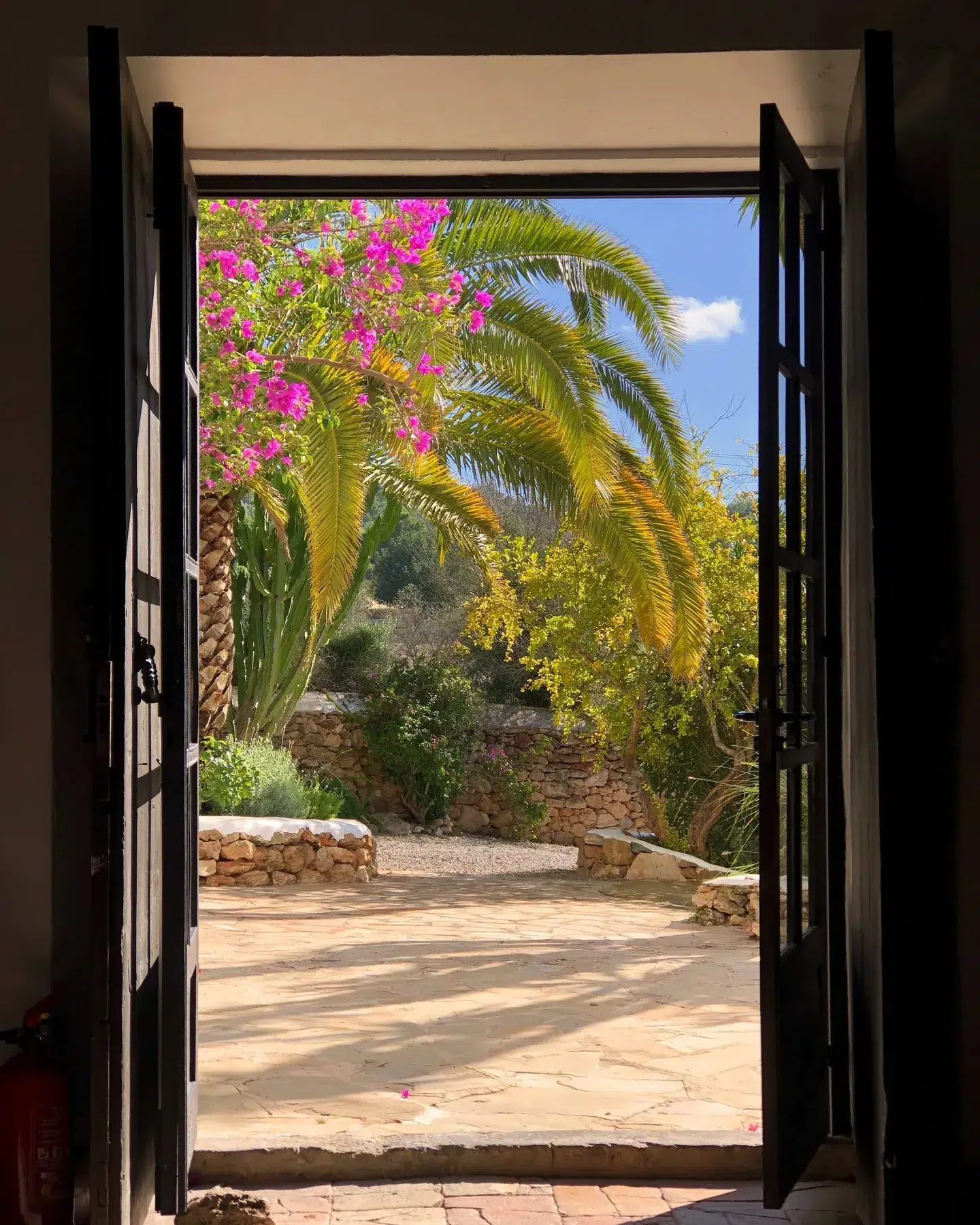 Looking into the lush Legado gardens through the entrance of the main house