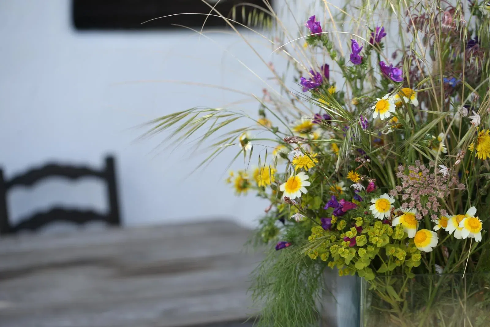 A bouquet of wildflowers on a vintage wooden table at Finca Legado